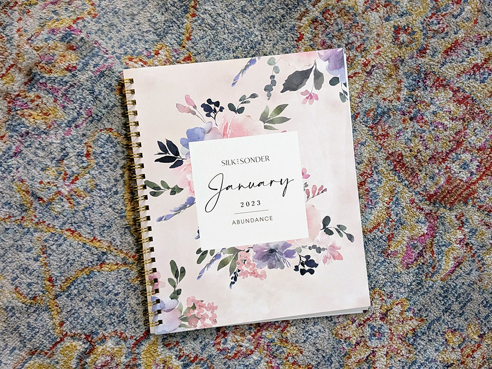 Silk and Sonder January 2023 planner with floral details and spiral binding