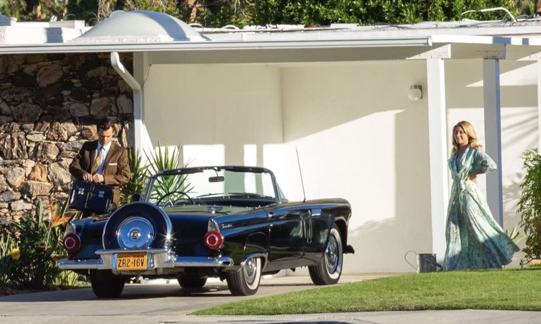 vintage car in front of a modern house in 'Don't Worry Darling'