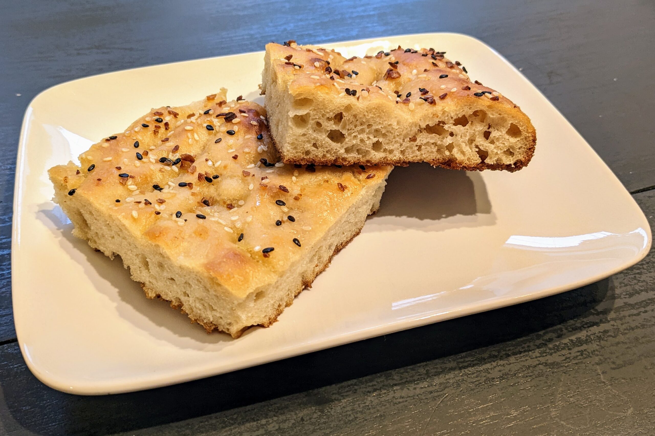 Everything Bagel Focaccia: two slices on a white rectangular plate