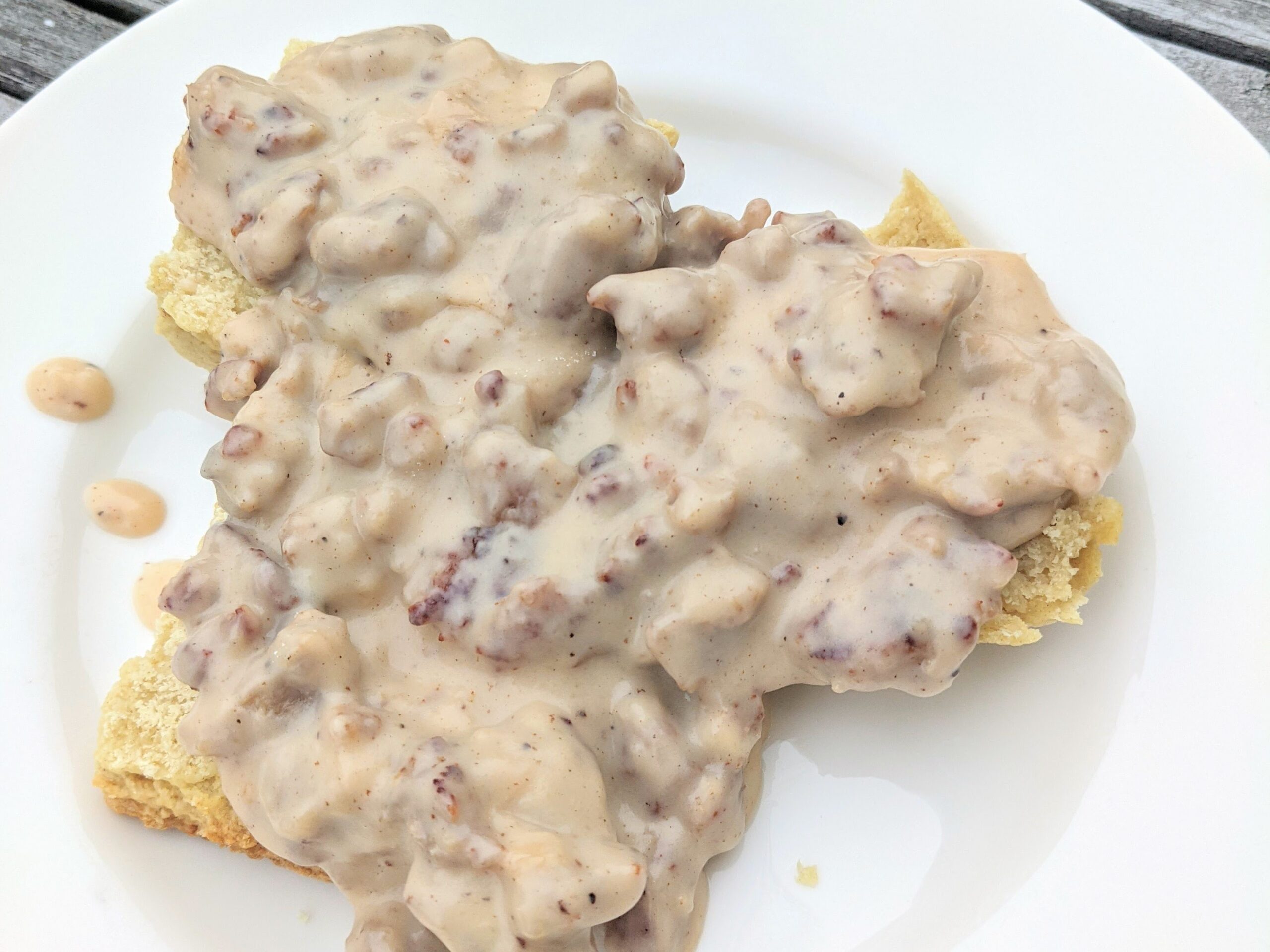 biscuits and gravy on a white plate; what to serve with this breakfast?