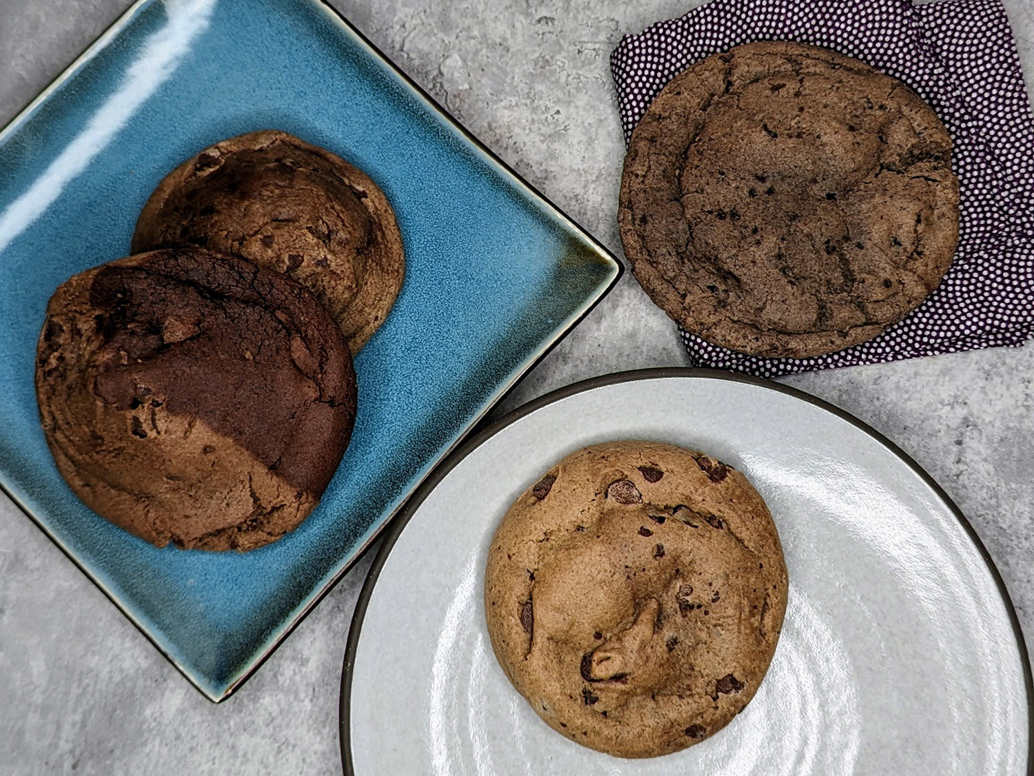 taylor chip cookies displayed side by side for taste testing: brookie, chocolate chip and oreo & cream