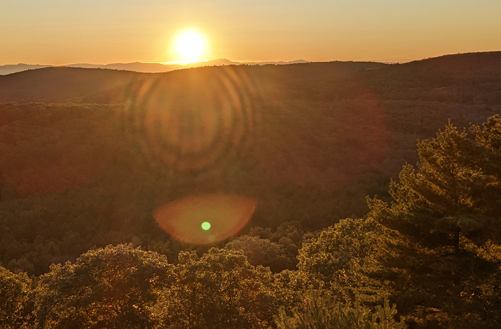 the sunset in upstate new york, overlooking trees