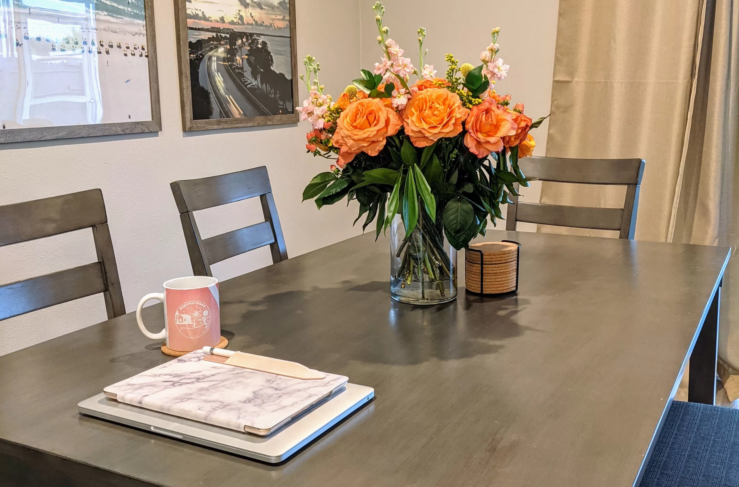 orange flowers next to an ipad and laptop, preparing to write Monday journal prompts